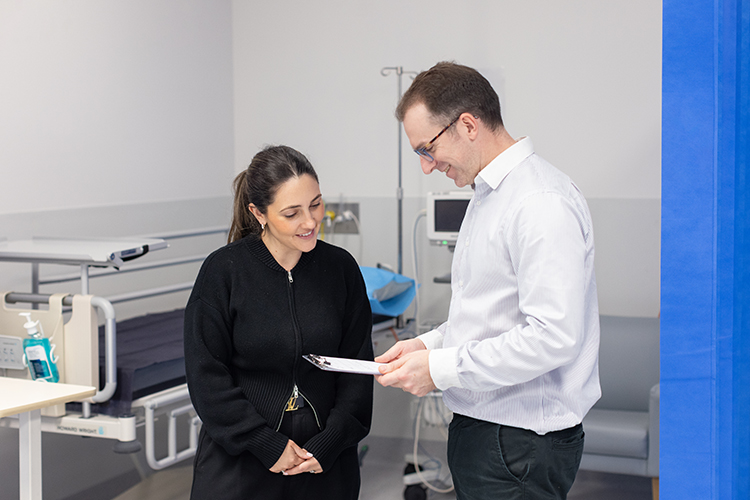 Person discussing imaging information with a medical professional in a consultation room