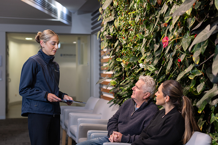 Reception staff speaking with patients in the Imaging at Olympic Park waiting area