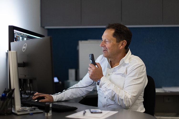 Medical imaging specialist reviewing diagnostic scans and digitally dictating a report at Imaging at Olympic Park